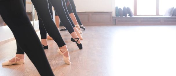 Die anmutigen Beine der Balletttänzer, die in einer Reihe auf den Zehenspitzen stehen - Foto, Bild