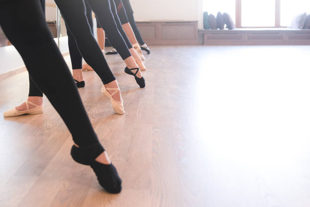 low section of The graceful legs of ballet dancers standing in a row on their toes - Foto, Imagem