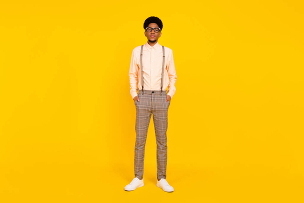 Full length body size photo man serious wearing stylish outfit glasses isolated vivid yellow color background - Фото, зображення