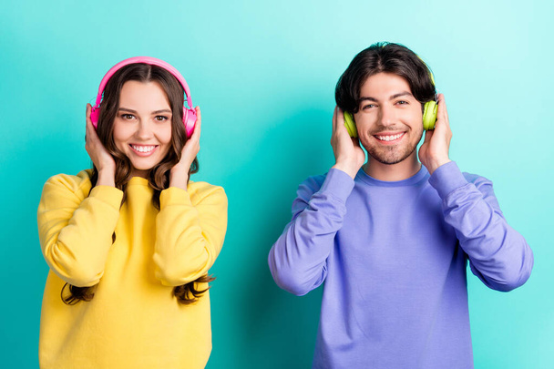 Photo of young couple happy positive smile listen music wireless headphones isolated over teal color background - Foto, imagen