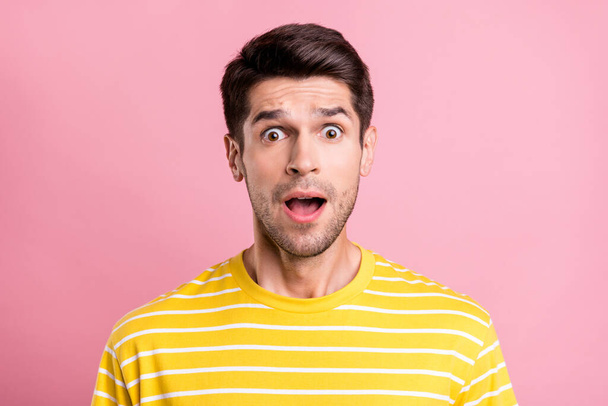 Portrait of attractive cheerful amazed worried guy staring eyes sudden news reaction isolated over pink pastel color background - Фото, изображение