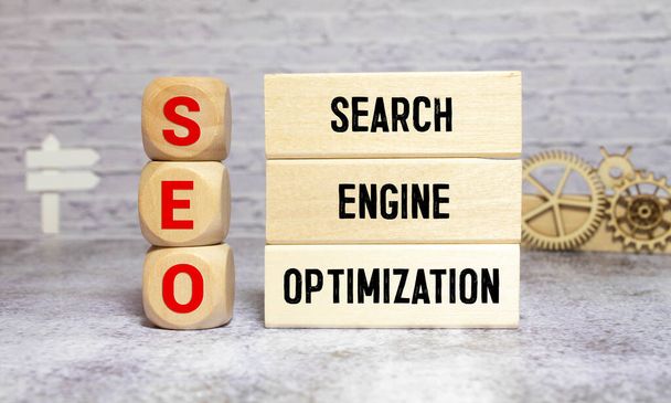 SEO Search Engine Optimization written on dices on blue background. - Фото, изображение
