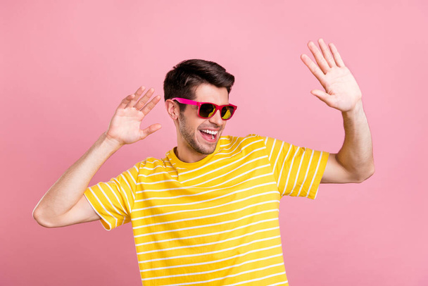 Portrait of attractive fashionable cheerful guy dancing having fun isolated over pink pastel color background - Φωτογραφία, εικόνα
