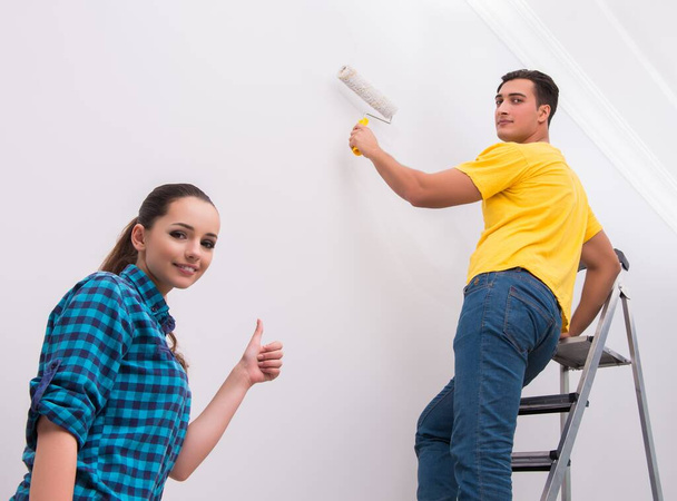 Young couple painting wall at home - Photo, Image