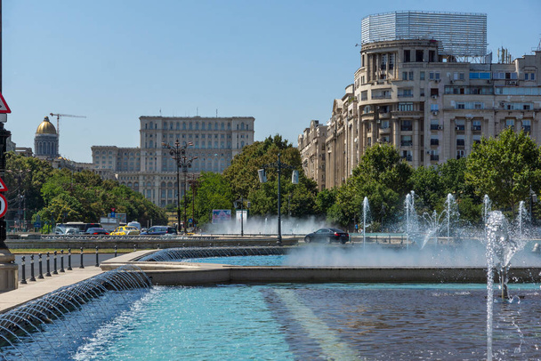 BUCHAREST, ROMANIA - AUGUST 17, 2021: Fountain at Unirii Square at the center of city of Bucharest, Romania - 写真・画像