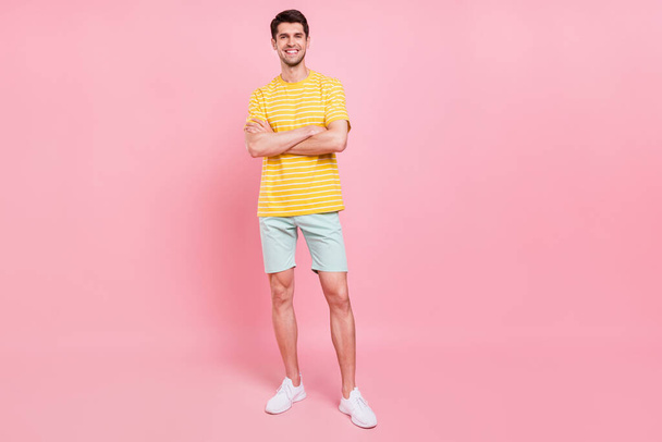 Full length photo of happy positive young man hold hands crossed confident isolated on pink color background - Zdjęcie, obraz