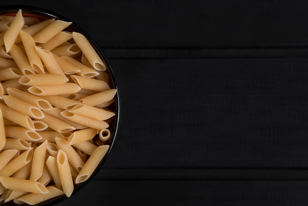 Large group of penne Italian pasta ready to be cooked . High quality photo - Zdjęcie, obraz