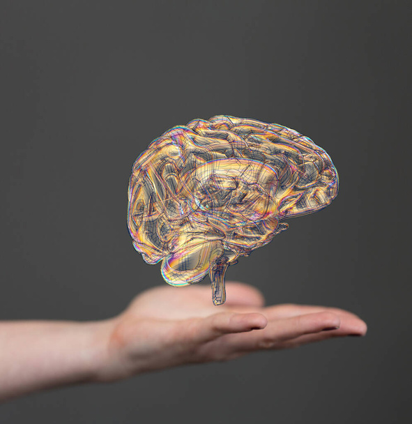 A vertical shot of a floating 3D human brain above hands - Photo, Image