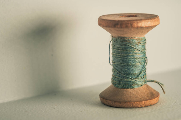 A closeup shot of a wooden stack of gray thread on an isolated background - Foto, immagini