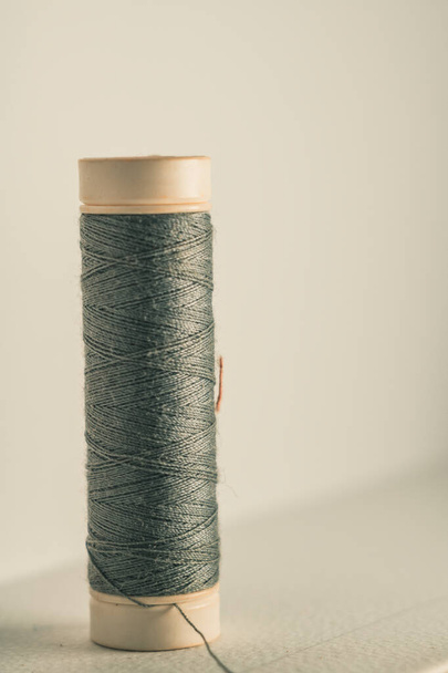 A vertical shot of a roll of gray thread on an isolated background - Photo, image