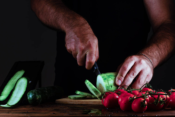 The man hands cutting vegetables - 写真・画像