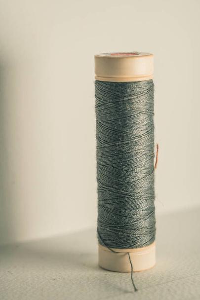 A vertical shot of rolls of gr thread on an isolated background - Фото, зображення