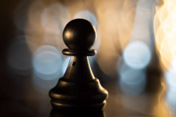 A closeup shot of a shiny metallic chess piece - Valokuva, kuva