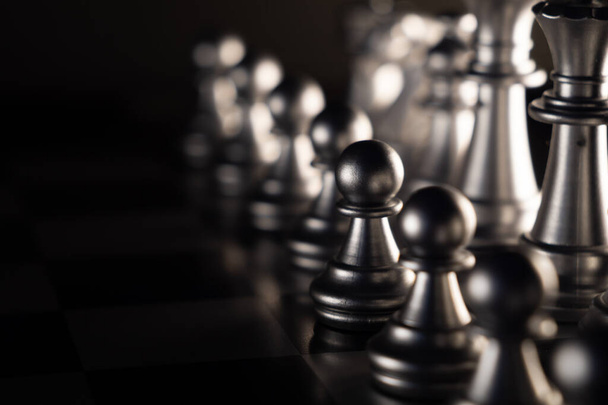 A closeup shot of a shiny metallic arranged chess board - Photo, image