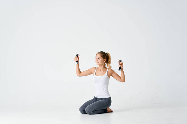 woman sitting on floor with dumbbells workout exercise - Fotoğraf, Görsel