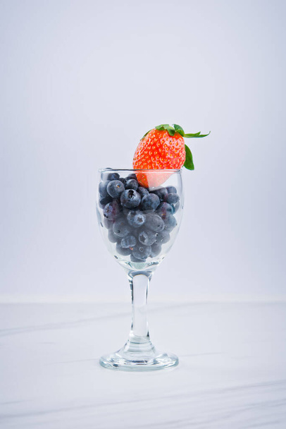 blueberries and strawberry in a bowl isolated on white. - Φωτογραφία, εικόνα