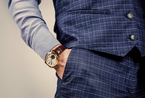Punctuality is essential in the business world. Luxury watch worn on male wrist. Elegant timepiece. Observing punctuality. Business time. Commitment to deadlines - Photo, image