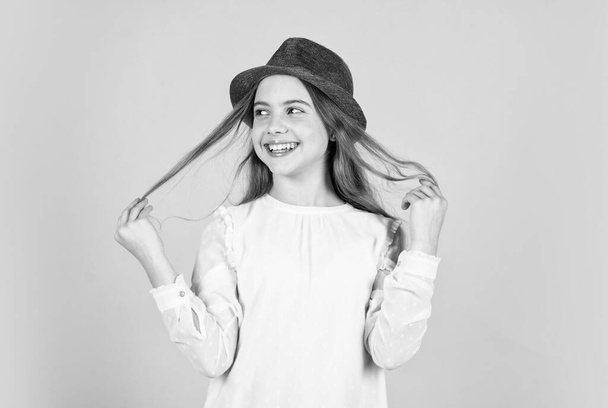 Long and healthy hair. retro girl blue background. happy little kid retro hat. vintage fashion look. summer accessory collection. small child long hair. beauty and style. Following her personal style - Foto, afbeelding