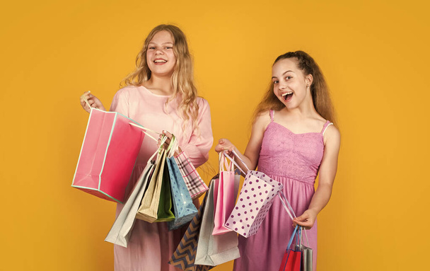 children hold shopping bags after successful shopping, purchase - Fotoğraf, Görsel
