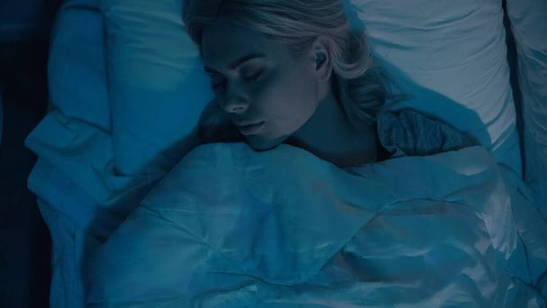 Top view of young woman sleeping at home at night  - Valokuva, kuva