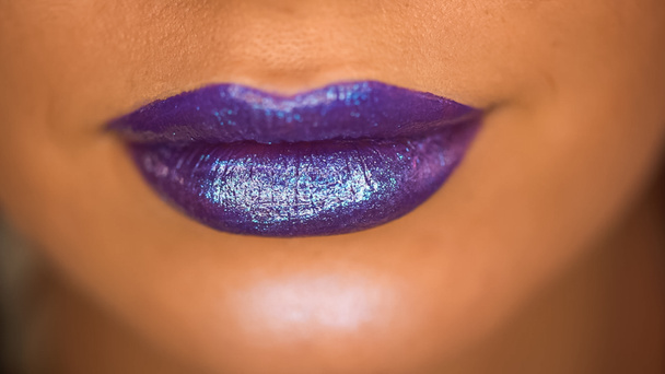 cropped view of woman with shimmer on purple lips  - Photo, Image