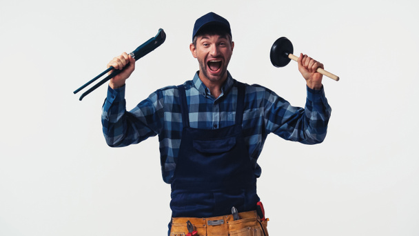 Excited handyman with tools looking at camera isolated on white  - Photo, Image
