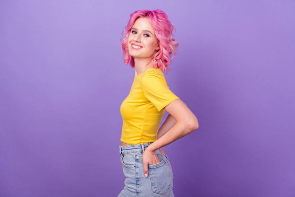 Profile side photo of young attractive girl happy positive smile hands in pocket dyed hair isolated over purple color background - Φωτογραφία, εικόνα