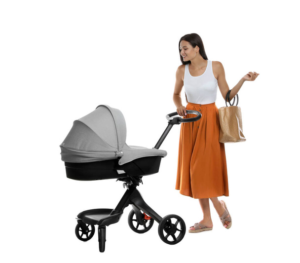 Happy young woman with baby stroller on white background - Fotoğraf, Görsel