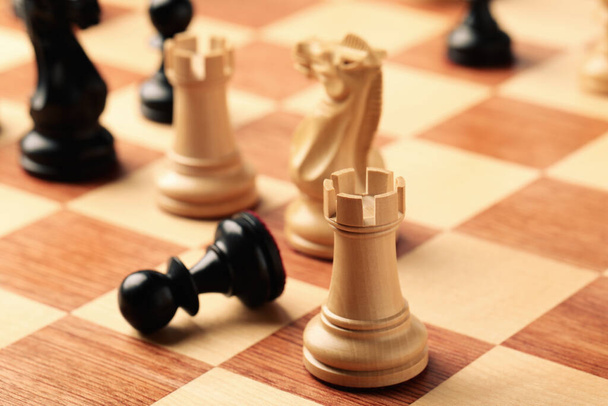 Wooden chessboard with game pieces, closeup view - 写真・画像