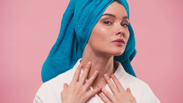 young woman with terry towel on head touching neck while looking at camera isolated on pink - Фото, изображение