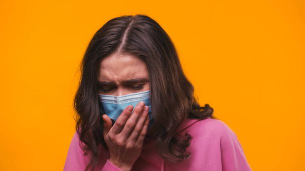 sick woman in medical mask coughing isolated on yellow - Photo, Image
