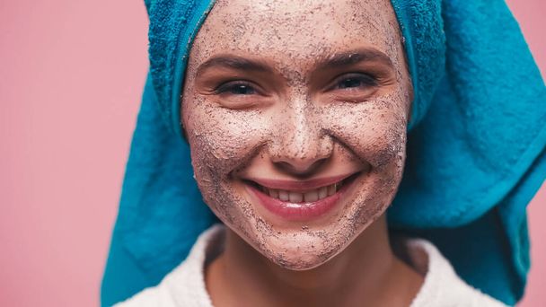 close up view of cheerful woman with scrub on face isolated on pink - Photo, Image