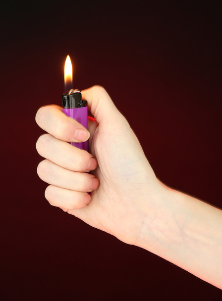 Burning lighter in female hand - Foto, afbeelding
