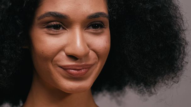 közeli kép a göndör afro-amerikai nő mosolyog elszigetelt szürke - Fotó, kép