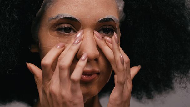 close up of african american woman applying sheet mask  - Fotografie, Obrázek