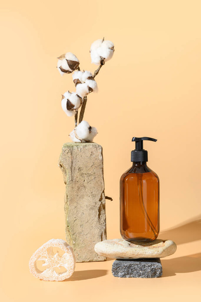 Balance composition with natural materials with stand and podium of stone, cotton flowers. Template, mock up, eco friendly monochrome composition on beige background. - Foto, afbeelding