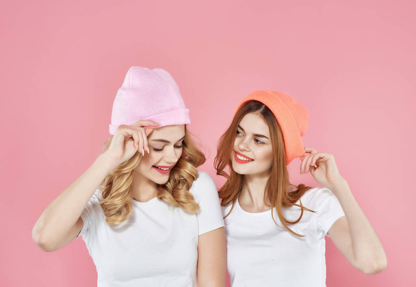 two girlfriends wearing hats modern style friendship fashion isolated background - Photo, Image