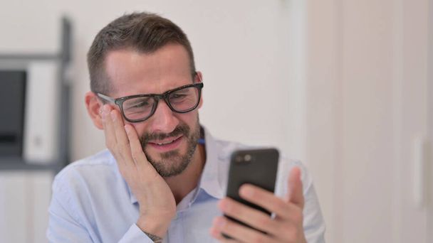 Portrait of Middle Aged Man having Loss on Smartphone  - Photo, image