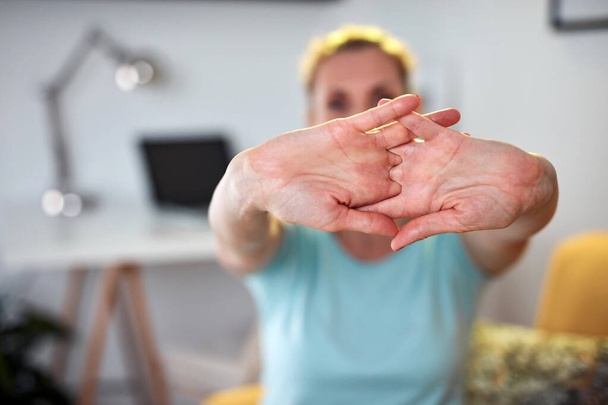 Woman with hand and arm pain at home. - Фото, изображение