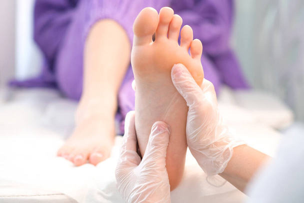 medical pedicure. foot massage with hands in transparent gloves. - Photo, Image
