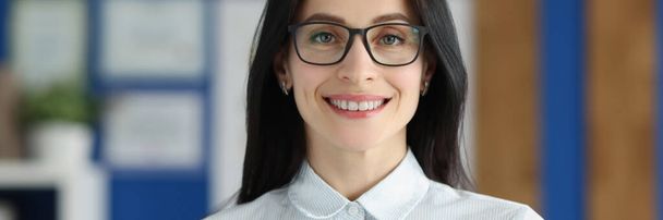 Smiling woman with glasses holding application for employment - Foto, afbeelding