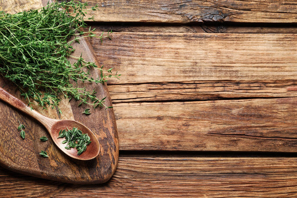 Bunch of aromatic thyme on wooden table, top view. Space for text - Foto, Imagem