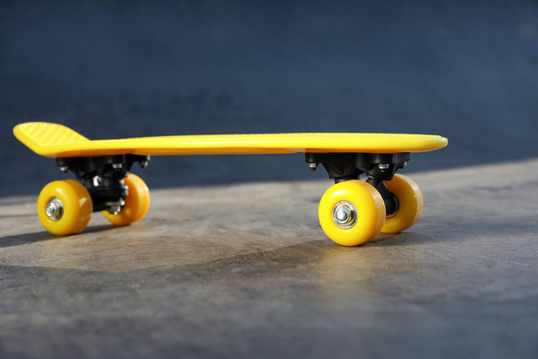 Modern yellow skate board outdoors. Sport equipment - Fotoğraf, Görsel