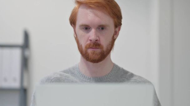 Young Beard Redhead Man using Laptop  - Photo, Image