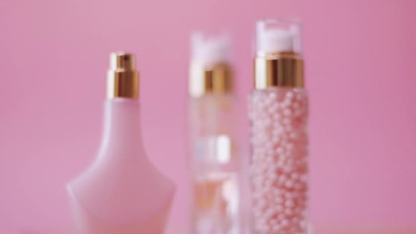 Conjunto de productos de maquillaje y cosméticos sobre fondo rosa - Metraje, vídeo