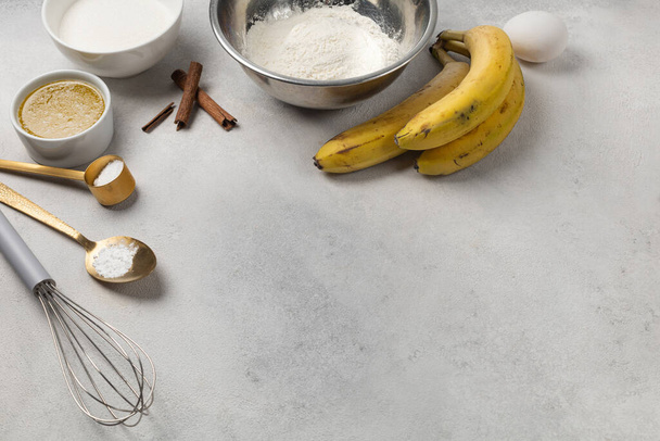 Ingredients for banana bread in bowls on light gray background top view - Photo, image