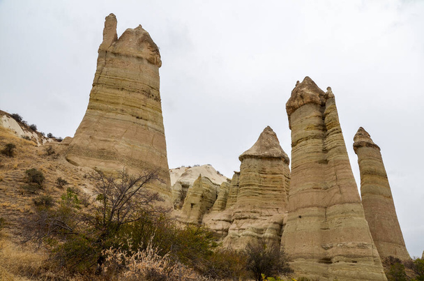 Unique famous limestone rock formations fairy chimney in the Love Valley in Cappadocia, Turkey - Foto, immagini