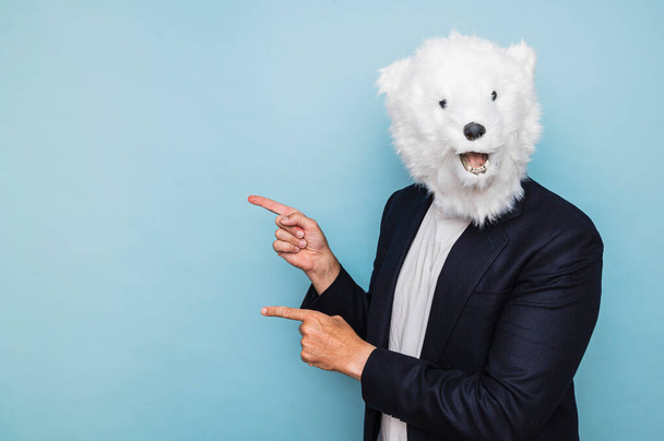 Man with polar bear mask pointing to the side. - Photo, Image