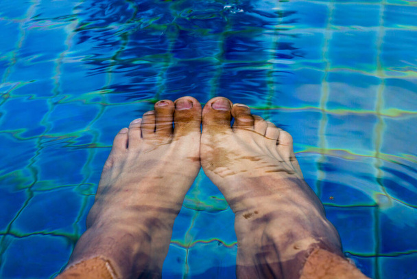 relax time ,man feet in the swiming pool under the water - Photo, Image