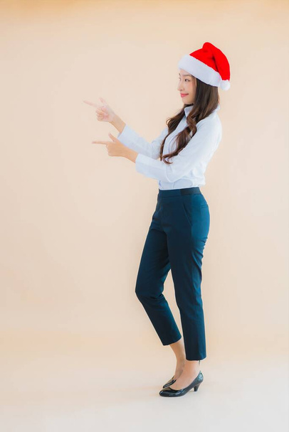 Portrait beautiful young business asian woman wear christmas hat on color isolated background - Foto, imagen